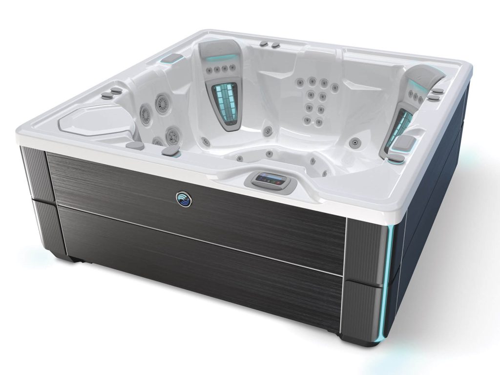 A modern, square hot tub with white interior and black exterior panels, featuring numerous jets and digital controls on the sides.