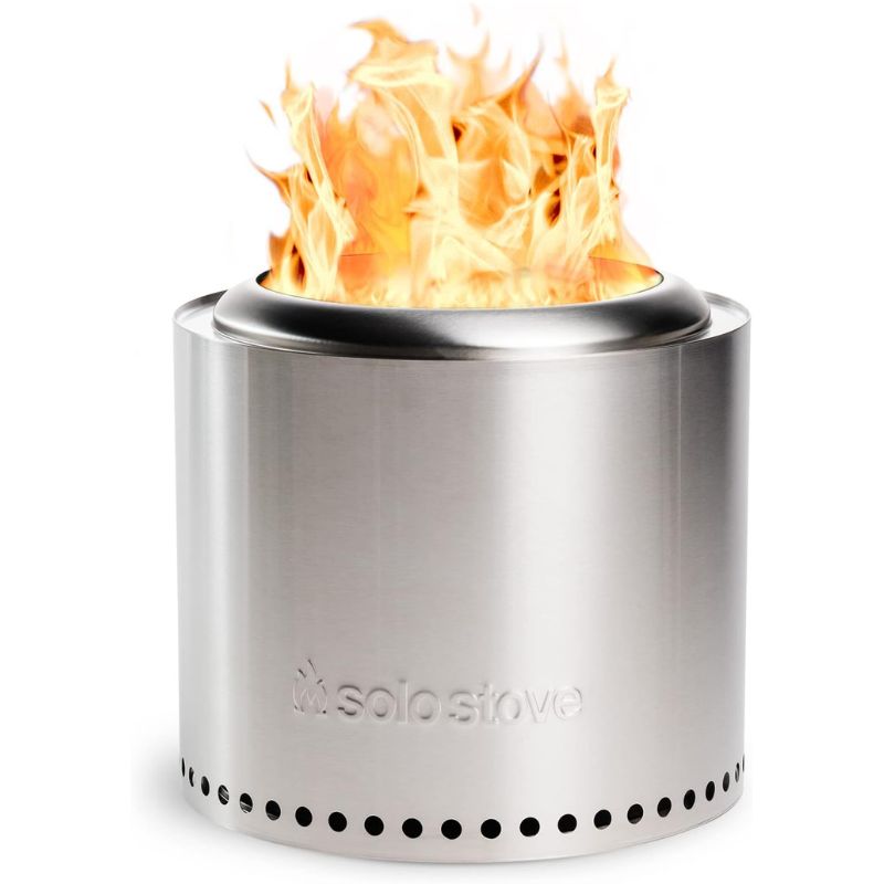 Stainless steel portable Solo Stove with vibrant flames rising, featuring a sleek design with vent holes around the bottom for airflow efficiency.